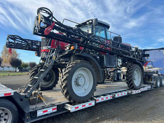 Buchanan Hauling Heavy Haul Division transports a piece of farm equipment machinery on a step deck flatbed. Buchanan Hauling Heavy Haul Division transports a piece of farm equipment machinery on a step deck flatbed.