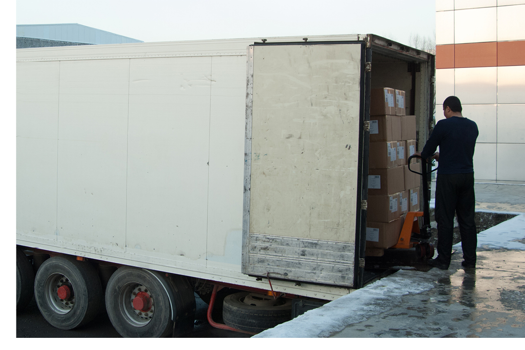 Man loading a semi trailer with freight to be shipped