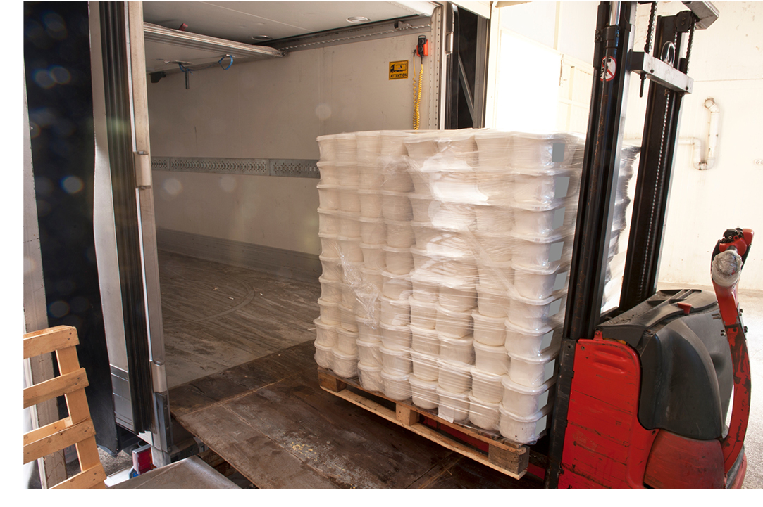 Semi truck being loaded by a forklift