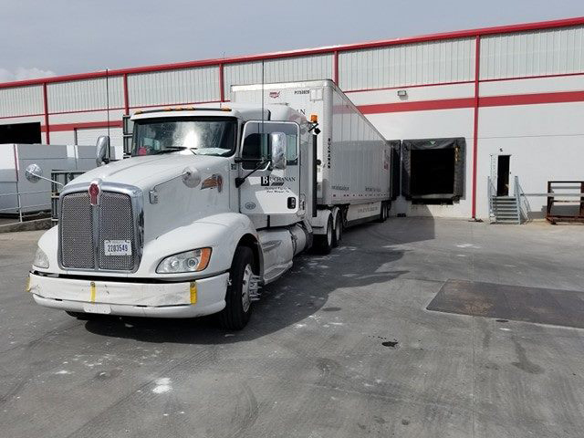 A Buchanan Hauling dry van truck parked at a terminal for delivery of freight.