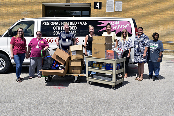 Happy crew smiles at all the goods donated by Buchanan staff