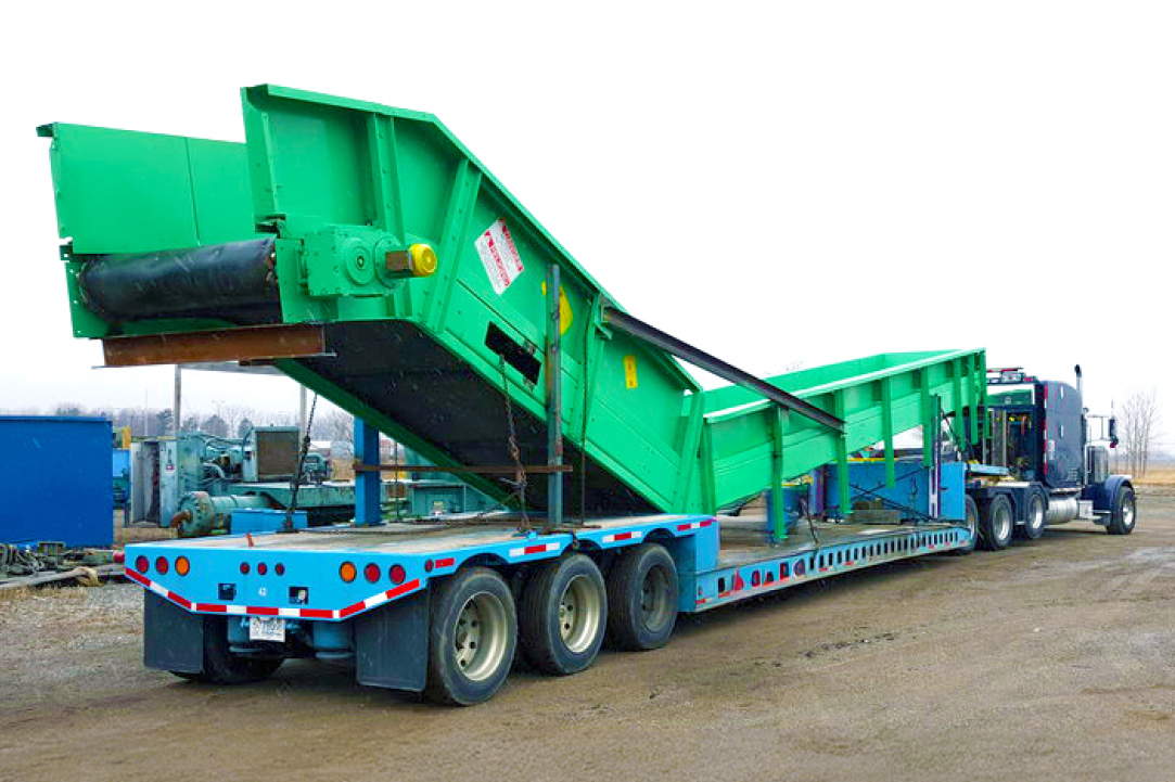 Buchanan Hauling and Rigging transports a conveyor or elevator system using their stepdeck trailer.